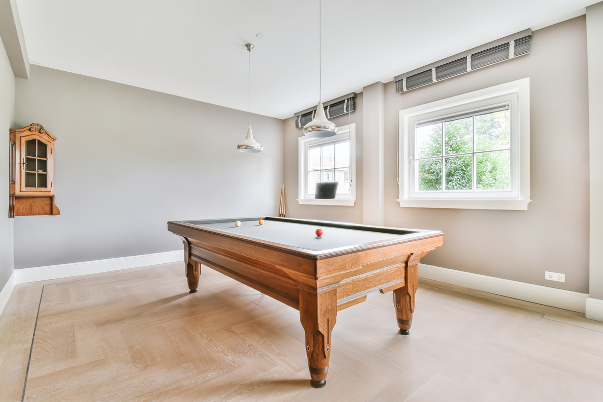 A Room with a Large Wooden Pool Table